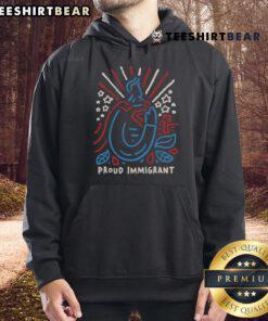 Proud immigrant wearing a hoodie with 'Top Here to Make a Difference' design, showcasing community spirit and pride.