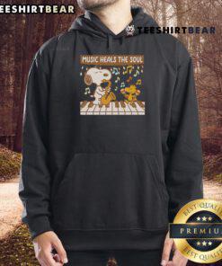 Cozy hoodie featuring Snoopy and Woodstock with the phrase 'Music Heals The Soul' perfect for Peanuts fans.