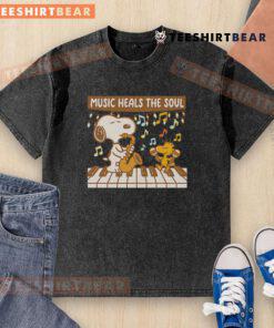 Top Snoopy and Woodstock piano music heals the soul washed t-shirt featuring playful cartoon design and vibrant colors.