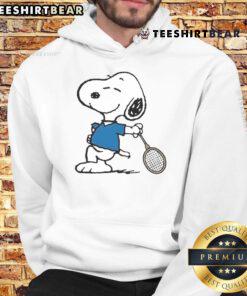 Alt Text: Snoopy as a tennis player cartoon on a cozy hoodie, perfect for fans of tennis and Peanuts character apparel.