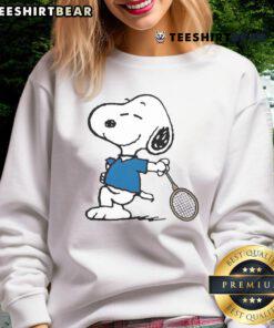 Cartoon sweatshirt featuring Snoopy as a top tennis player, perfect for fans of Peanuts and sports apparel.