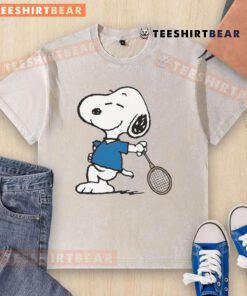 Cartoon Snoopy as a tennis player on a washed t-shirt, showcasing fun sports fashion and playful design.