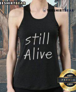 Stylish Top Still Alive tank top displayed on a hanger, featuring vibrant colors and a trendy design for summer fashion.