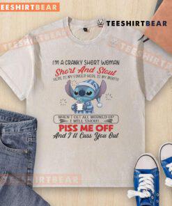 Alt Text: Cranky short woman wearing a I'm A Cranky Short And Stout washed t-shirt, playfully showing her finger and mouth.