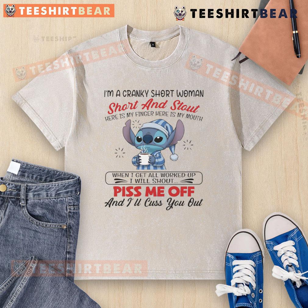 Alt Text: Cranky short woman wearing a I'm A Cranky Short And Stout washed t-shirt, playfully showing her finger and mouth.