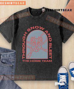 Top The Home Team Through Snow and Sleet washed t-shirt displayed on a rustic wooden background, showcasing its unique design.