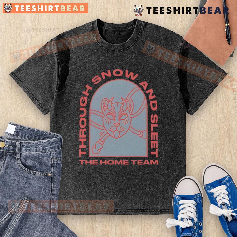 Top The Home Team Through Snow and Sleet washed t-shirt displayed on a rustic wooden background, showcasing its unique design.
