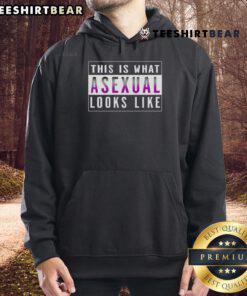 A person wearing a 'Top This Is What Asexual Looks Like' hoodie, showcasing a vibrant design and a confident expression.