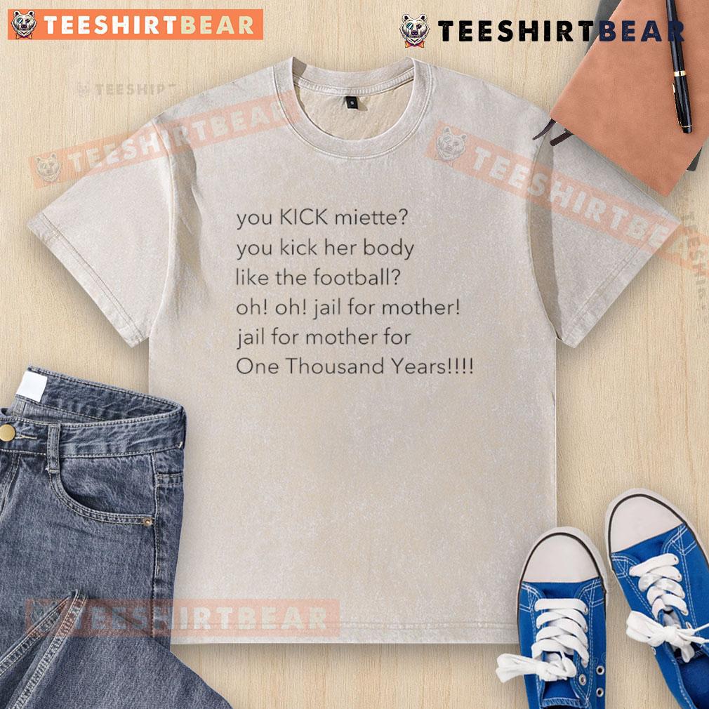 Alt Text: Top You Kick Miette You Kick Her Body Like The Football washed t-shirt featuring a playful football graphic design.