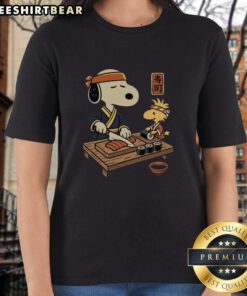 Alt Text: Cute Snoopy and Woodstock sushi design on a Tomodachi Club ladies tee, perfect for Peanuts fans and sushi lovers.