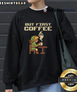 Funny 'But First Coffee' sweatshirt featuring retro gamer pixel art inspired by The Legend of Zelda.
