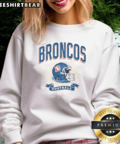 Distressed vintage sweatshirt featuring a Denver Broncos football helmet design for fans and collectors.