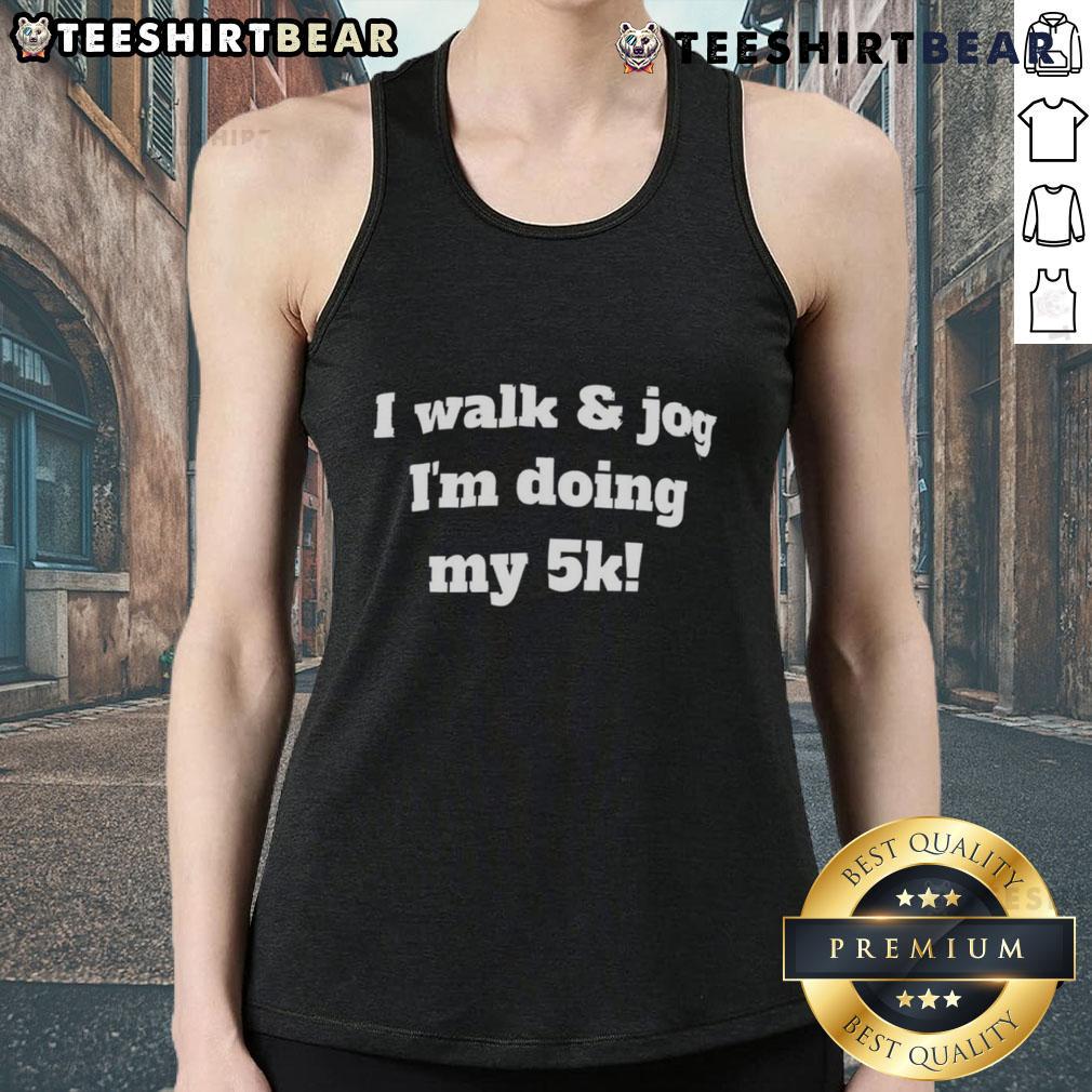 Runner wearing a 'Good I Walk and Jog I'm Doing My 5K' tank top during a 5K race, showcasing fitness and motivation.