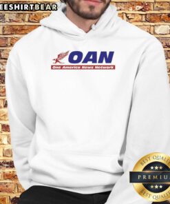 Alt Text: Mike Gundy wearing a One America News Network hoodie, showcasing his support for OAN in a casual setting.
