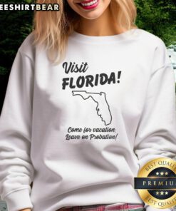 Official Visit Florida sweatshirt with 'Come for vacation, leave on probation' slogan, showcasing fun travel humor.