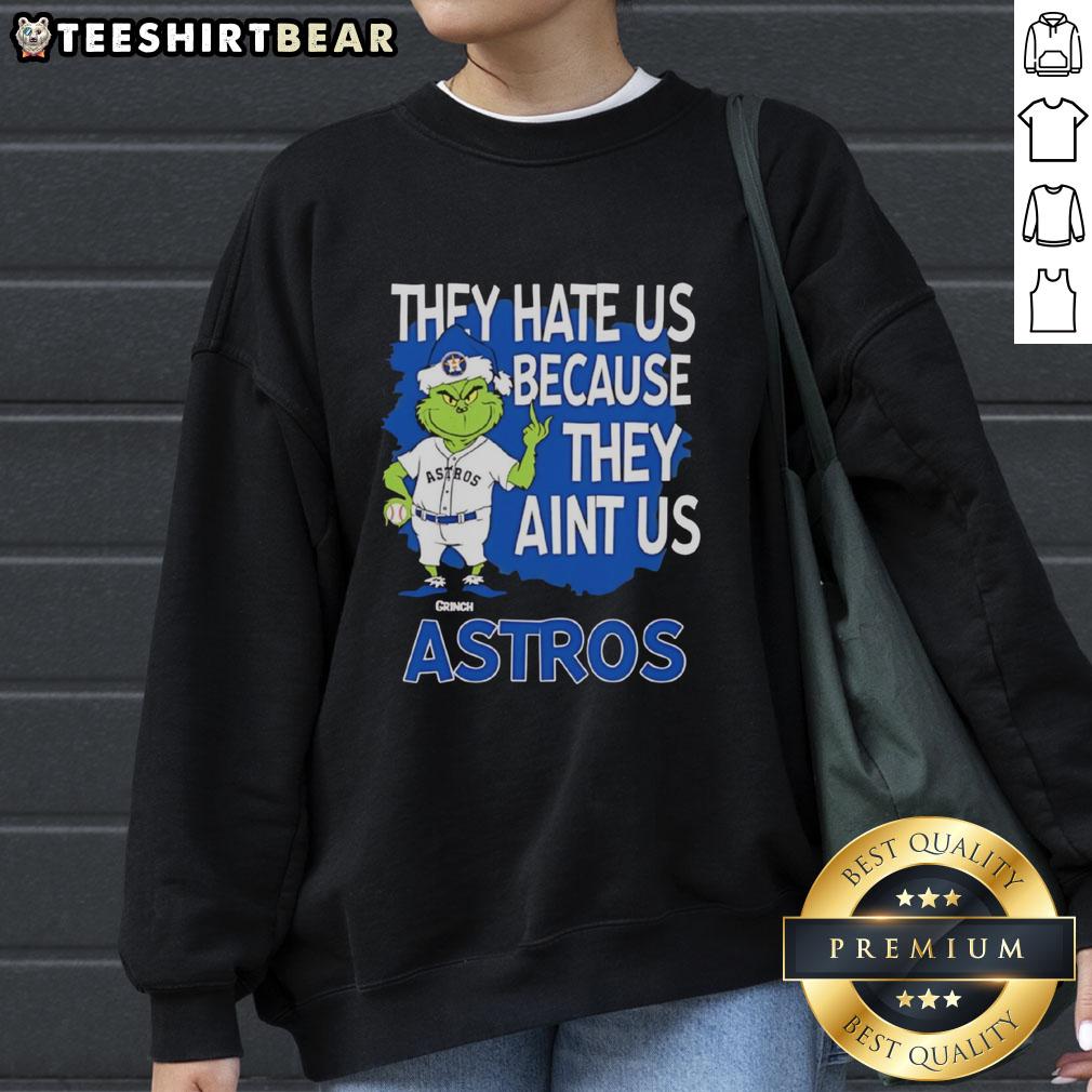 Top Houston Astros Grinch Christmas sweatshirt featuring 'They Hate Us Ain't Us' design for festive baseball fans.