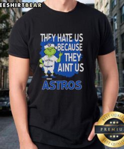 Top Houston Astros Grinch Christmas T-Shirt featuring 'They Hate Us Ain't Us' design, perfect for holiday cheer.
