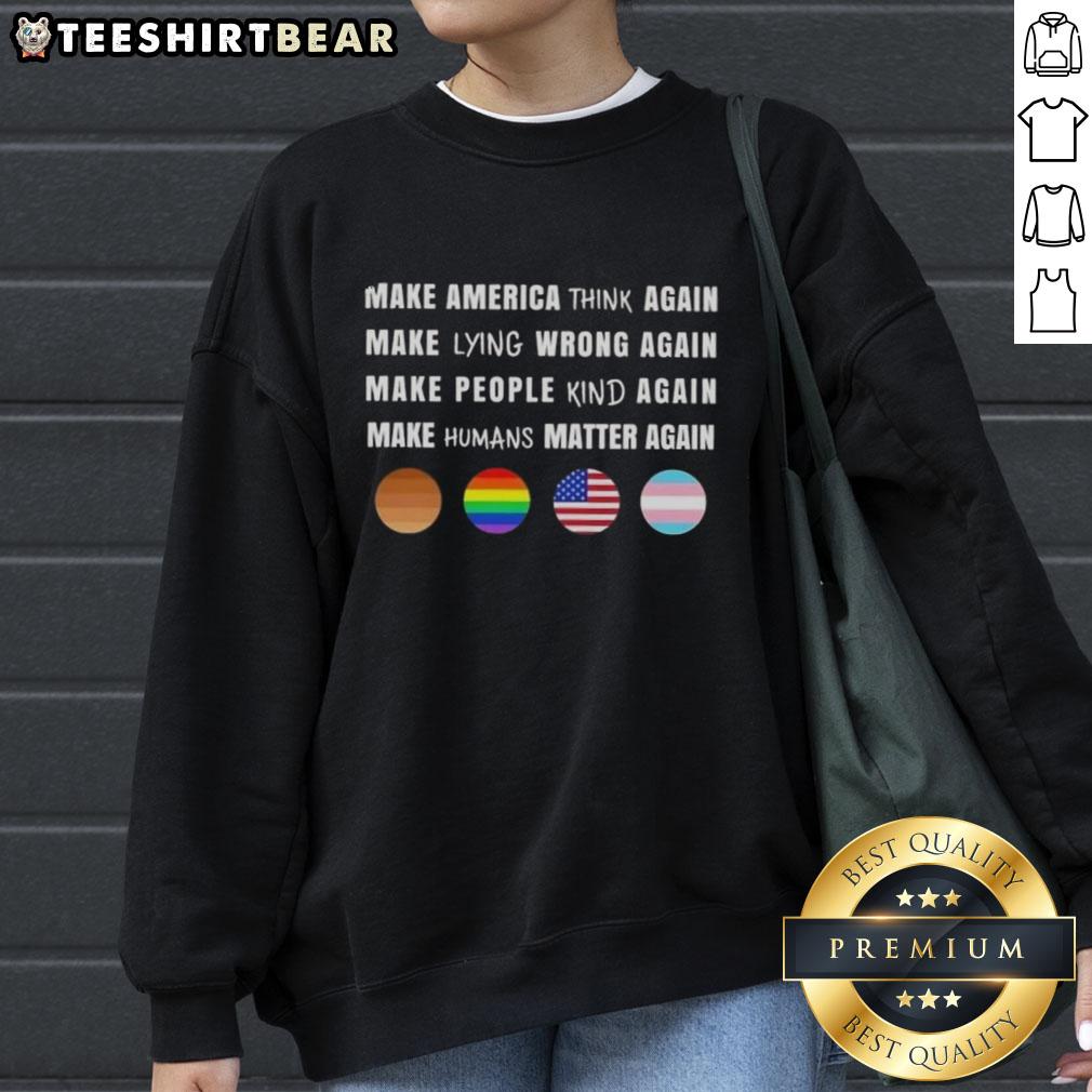 Alt Text: Men and women wearing 'Make America Think Again' sweatshirt promoting values of honesty and humanity.