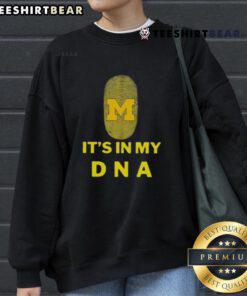 Cozy Top Michigan It's In My DNA sweatshirt displayed on a wooden table, perfect for proud Michiganders.