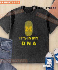 Top Michigan It's In My DNA washed t-shirt displayed on a wooden surface, showcasing a casual and stylish design.
