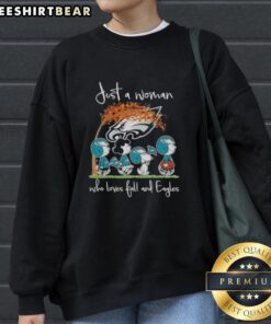 Woman wearing a cozy sweatshirt with 'Just a Woman Who Loves Fall and Philadelphia Eagles Football' design.