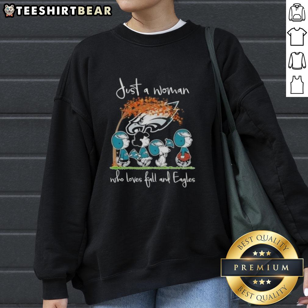 Woman wearing a cozy sweatshirt with 'Just a Woman Who Loves Fall and Philadelphia Eagles Football' design.