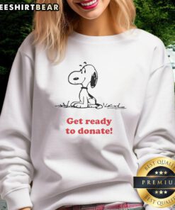 Top Peanuts x American Red Cross sweatshirt ready for donation, featuring fun graphics and a cozy design for a good cause.