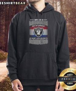 Alt Text: Person wearing Raiders hoodie expressing team spirit in Missouri on game day, showcasing love for the Raiders.
