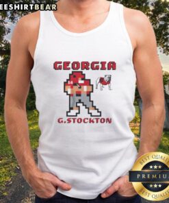 Gunner Stockton wearing a retro Georgia Bulldogs football tank top at a game, showcasing team spirit and style.