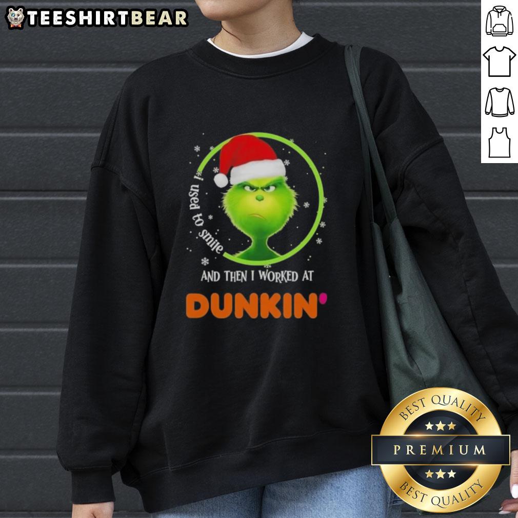 Cozy sweatshirt featuring a Grinch graphic with 'I Used to Smile and Then I Worked at Dunkin' Donuts' text.