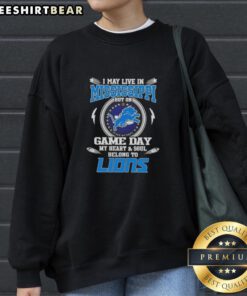 Alt Text: Cozy sweatshirt featuring I May Live In Mississippi But On Game Day My Heart Belongs To Detroit Lions design.