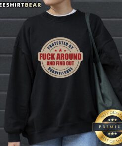 Top-Protected-By-Surveillance-Fck-Around-And-Find-Out-Sweatshirt featuring bold design and cozy fabric for casual wear.