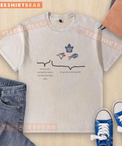 Excited fan wearing a washed T-shirt featuring top Toronto Blue Jays, Maple Leafs, and Buffalo Bills logos.