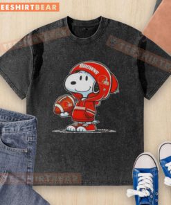 Premium Peanuts Snoopy in a Cleveland Browns hoodie smiling at fans on a washed t-shirt design.
