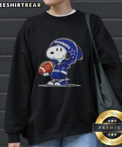 Alt Text: Snoopy in a Dallas Cowboys hoodie smiles at fans on a premium peanuts sweatshirt, showcasing playful team spirit.