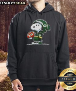 Snoopy in a Green Bay Packers hoodie smiles at fans, showcasing premium peanuts merchandise in a fun, sporty vibe.