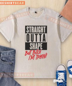 Alt Text: Nice Straight Outta Shape But Bitch I'm Trying washed t-shirt displayed on a hanger, featuring a casual, trendy design.