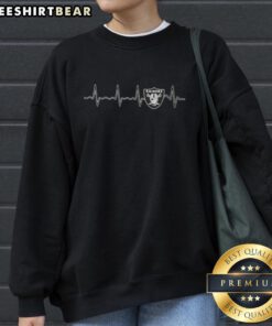 Alt Text: Official Heartbeat Las Vegas Raiders football logo graphic sweatshirt featuring bold design and team colors.