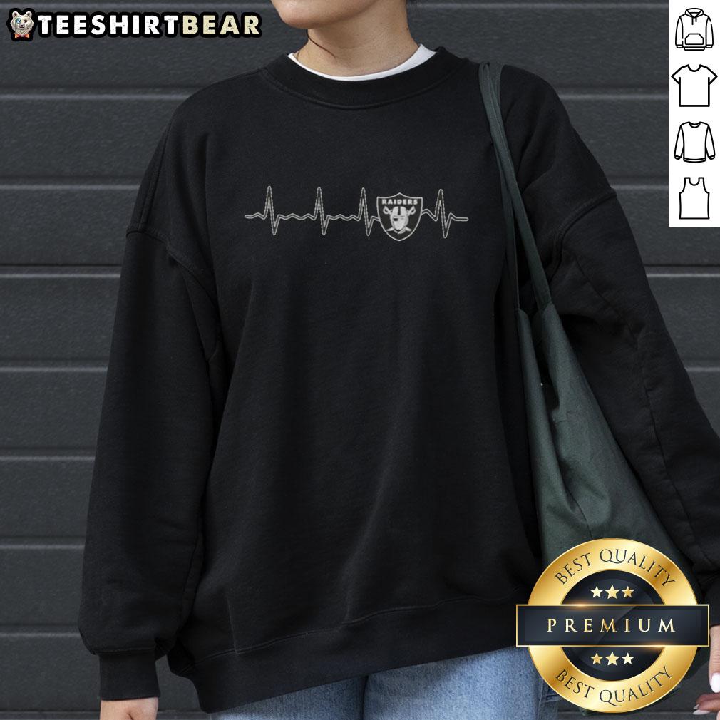 Alt Text: Official Heartbeat Las Vegas Raiders football logo graphic sweatshirt featuring bold design and team colors.