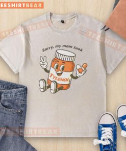 Cartoon graphic on a washed t-shirt featuring 'Please Be Patient, Sorry My Mom Took Tylenol' text design.
