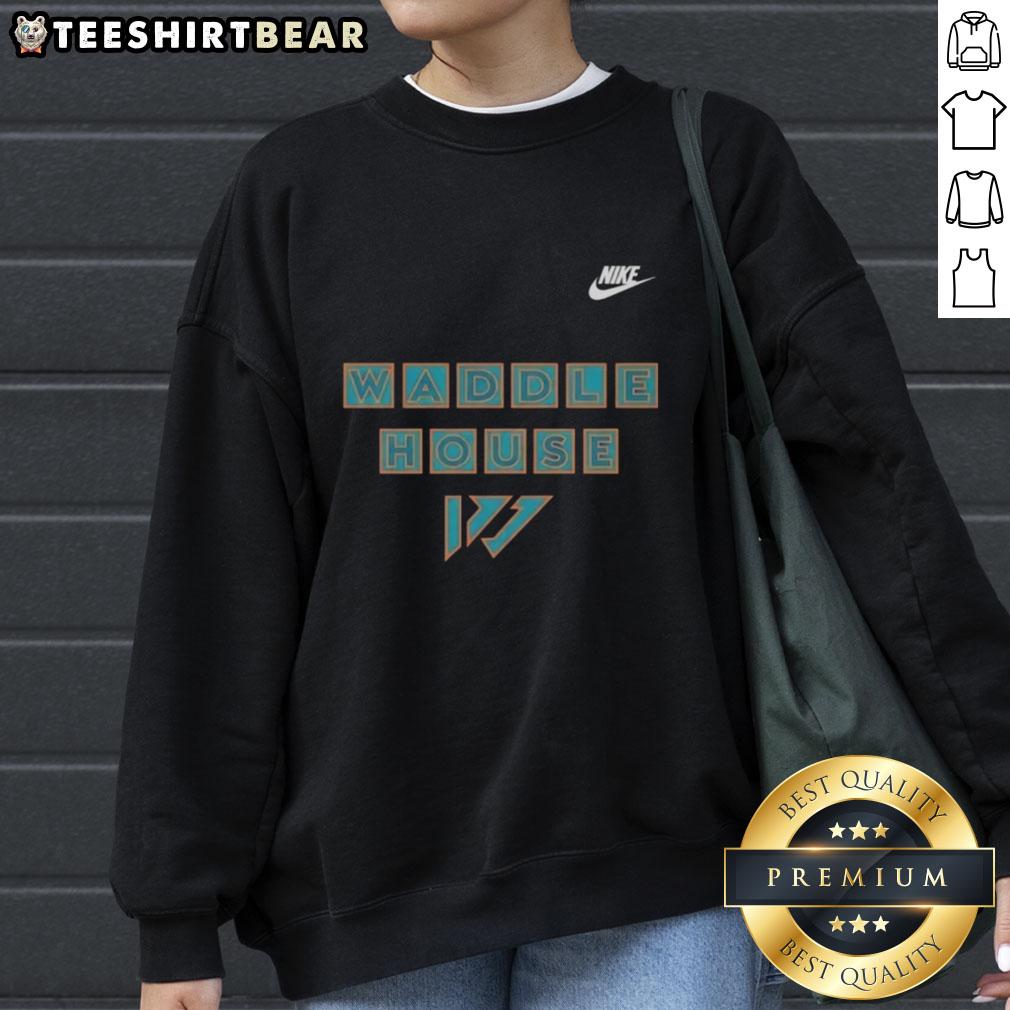Jaylen Waddle in a premium Miami Dolphins sweatshirt, showcasing Waddle House style and team spirit.