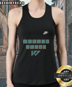 Jaylen Waddle in a Miami Dolphins tank top at Waddle House, showcasing team spirit and style.
