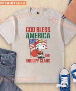 Premium Peanuts God Bless America Snoopy Claus washed t-shirt featuring a festive design for patriotic holiday spirit.