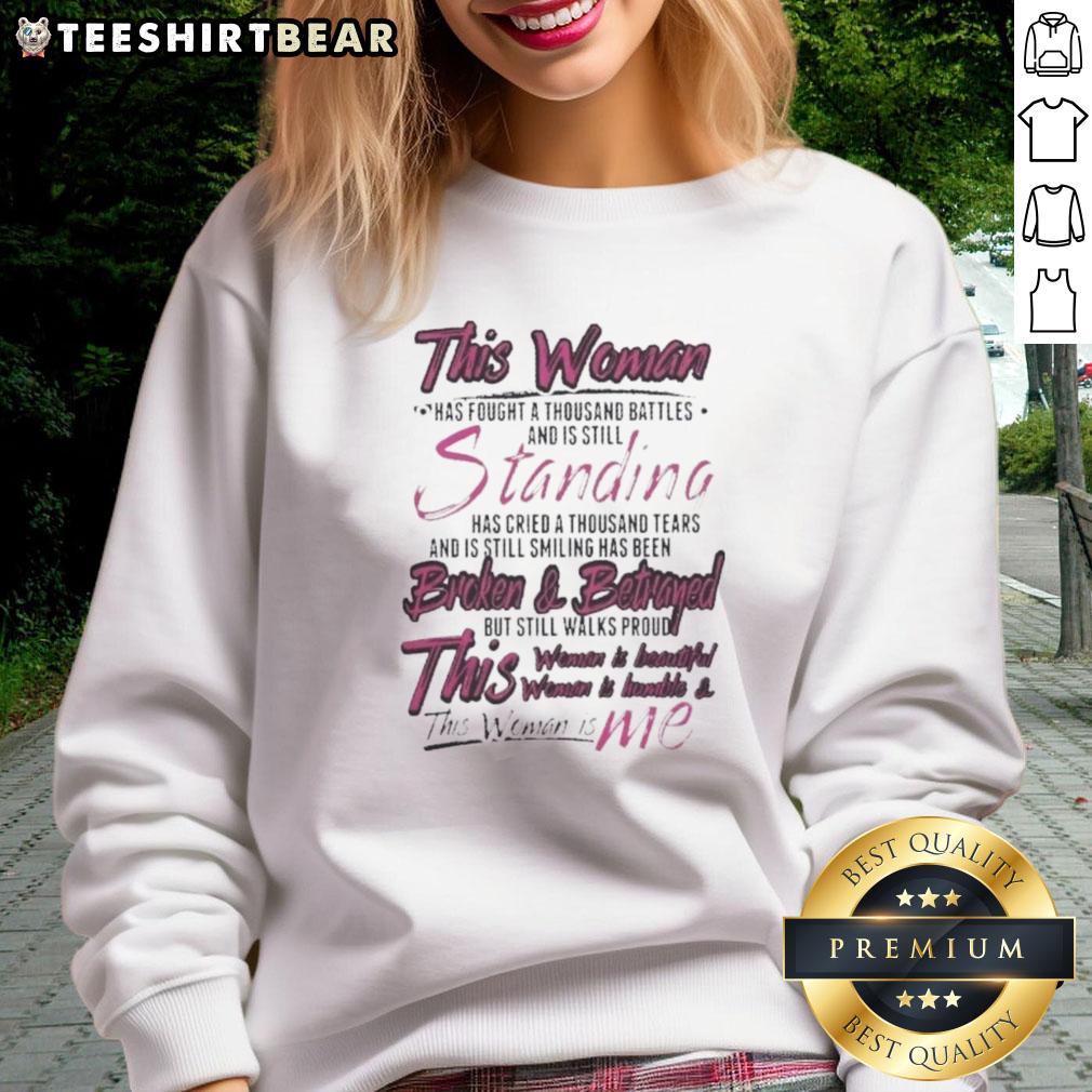 Premium sweatshirt featuring inspirational quote: 'This woman has fought a thousand battles, still standing, cried a thousand tears, still smiling.'