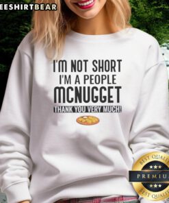 Cozy sweatshirt featuring 'Pretty I'm Not Short I'm A People McNugget Thank You Very Much' in playful typography.