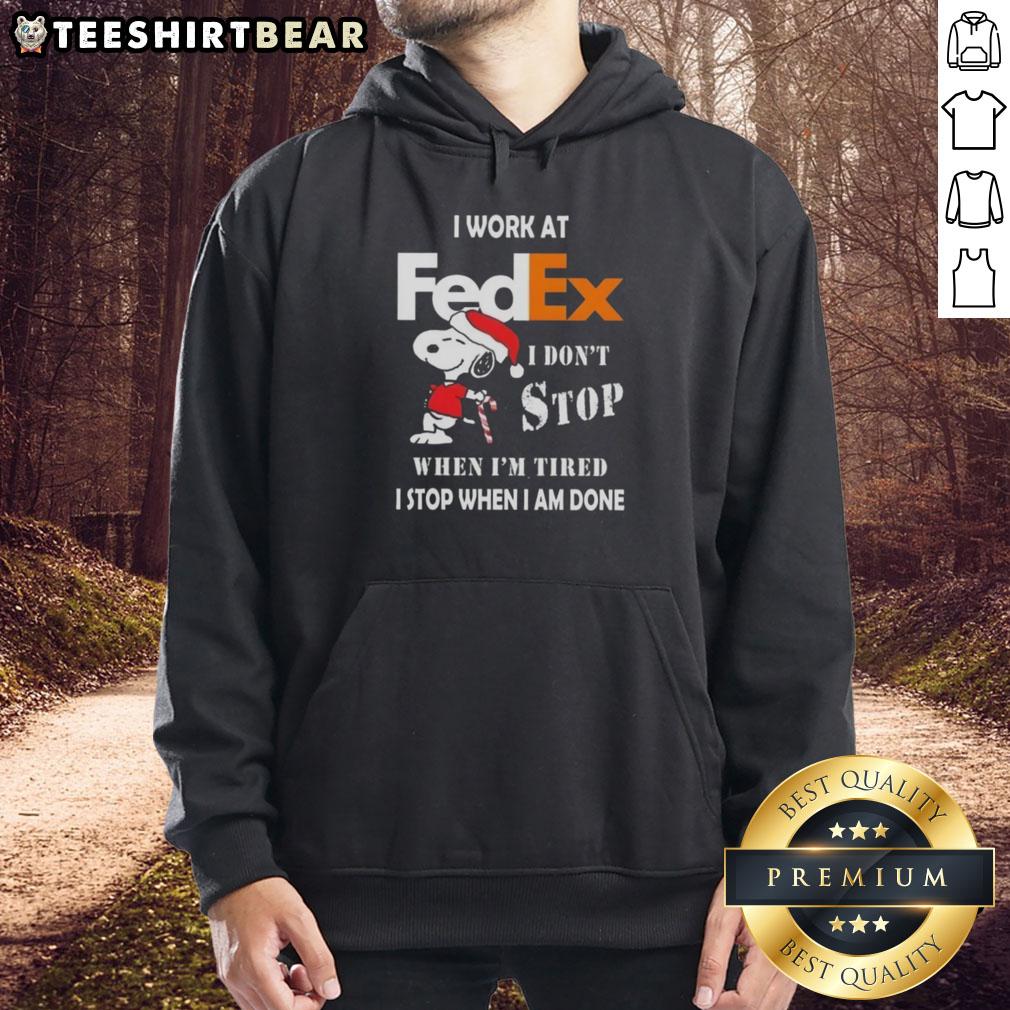 Alt Text: Pretty Snoopy Christmas hoodie with 'I work at FedEx, I don't stop when I'm tired, I stop when I'm done' text.