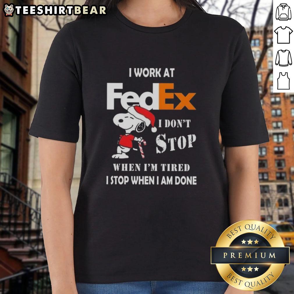 Alt Text: Pretty Snoopy Christmas tee for ladies with 'I work at FedEx, I don't stop when I'm tired' slogan.