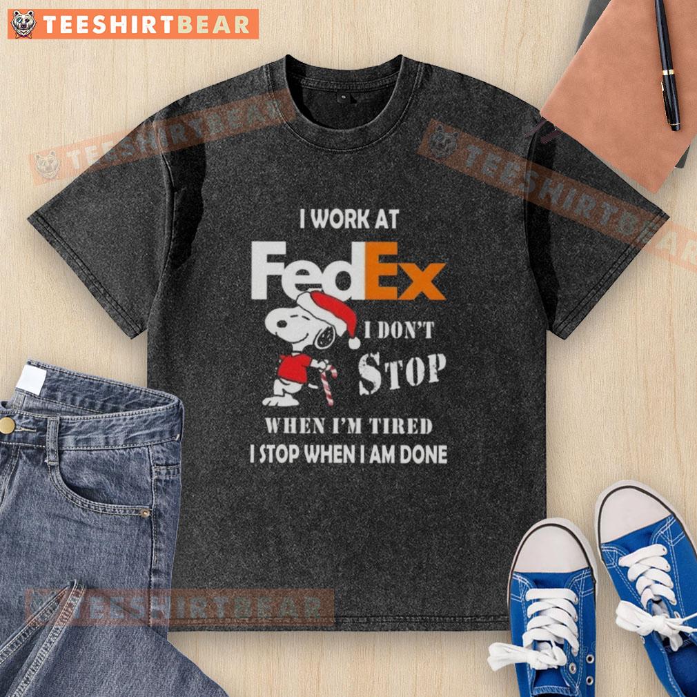 Alt Text: Cute Snoopy graphic on a Christmas-themed washed t-shirt for FedEx, featuring the quote about hard work and dedication.
