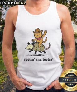 Top Cowboy orange cat riding an opossum in a fun Rotin and Tootin tank top, showcasing a playful and whimsical scene.