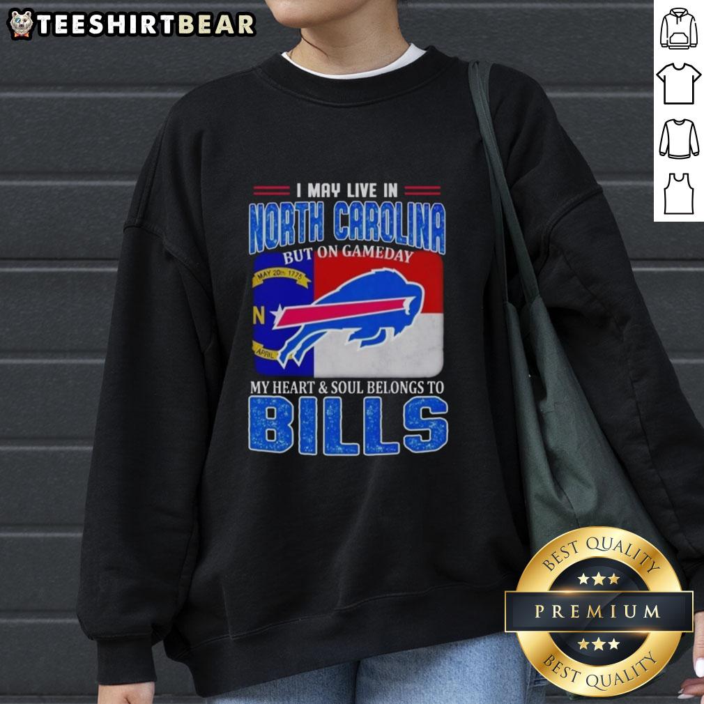 Cozy sweatshirt featuring 'I May Live In North Carolina But On Gameday My Heart Belongs To Bills' design, perfect for fans.